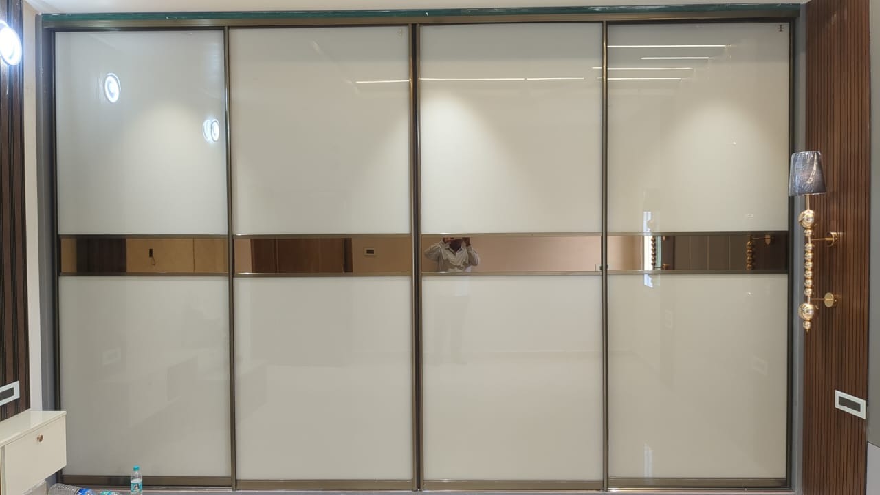 Ajay's House, Ballari — Four-shutter sliding wardrobe with bronze mirror band